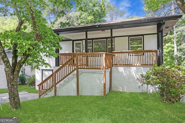 644 Church St NW, Atlanta, GA 30318 - back of house with brick siding, a lawn, and covered porch