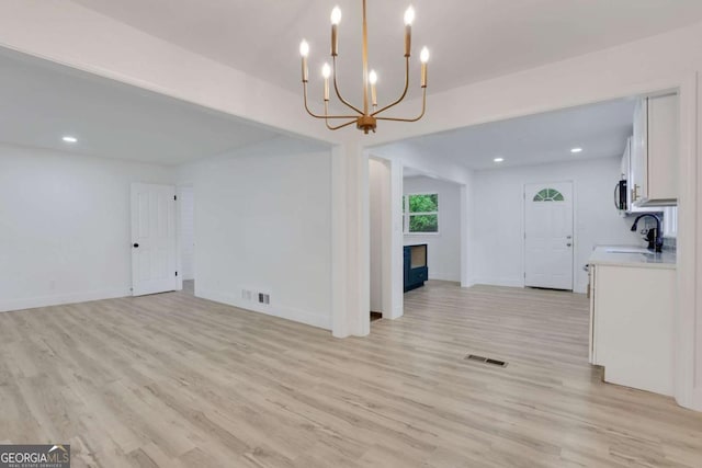 644 Church St NW, Atlanta, GA 30318 - unfurnished living room featuring a fireplace, a chandelier, light wood-type flooring, and recessed lighting