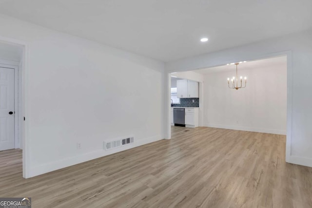 644 Church St NW, Atlanta, GA 30318 - unfurnished living room with a chandelier, light wood-style floors, and recessed lighting