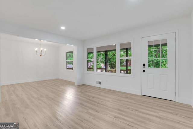 644 Church St NW, Atlanta, GA 30318 - unfurnished living room with a chandelier, light wood-style floors, plenty of natural light, and recessed lighting