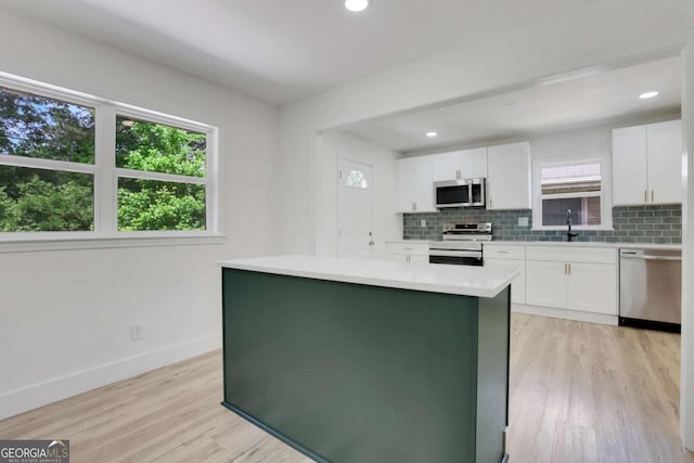 644 Church St NW, Atlanta, GA 30318 - kitchen featuring stainless steel appliances, decorative backsplash, light countertops, white cabinetry, and recessed lighting