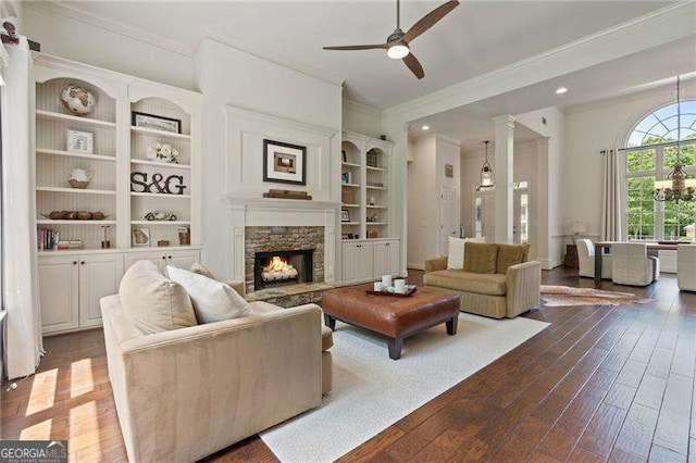 living area with crown molding, ceiling fan, dark wood finished floors, a fireplace, and recessed lighting