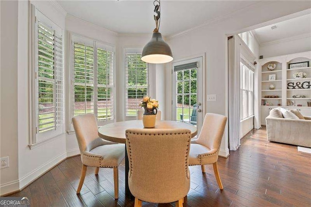 dining area with baseboards, dark wood finished floors, and ornamental molding
