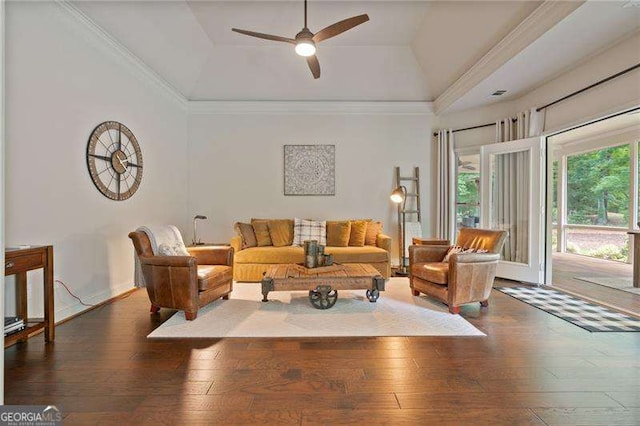living room featuring a ceiling fan, hardwood / wood-style flooring, a tray ceiling, lofted ceiling, and crown molding