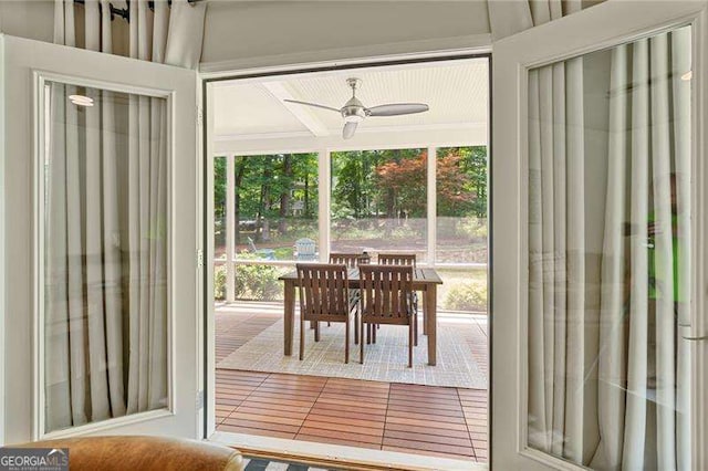 entryway with ceiling fan and tile patterned floors