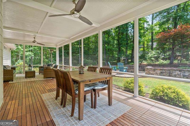 sunroom featuring a ceiling fan, an outdoor living space, and outdoor dining space