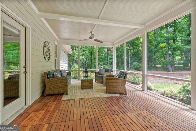 sunroom with an outdoor living space and a ceiling fan