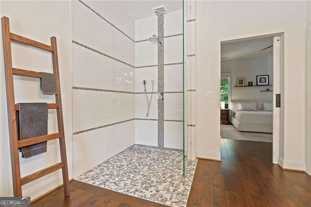 hall featuring hardwood / wood-style floors and baseboards