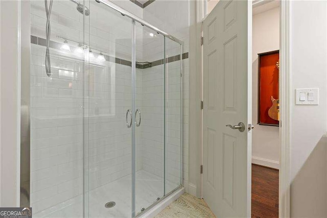 full bath with a shower stall