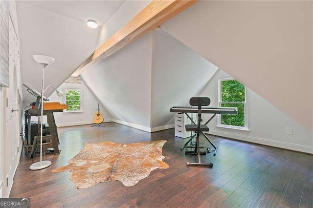 additional living space featuring lofted ceiling, wood finished floors, and baseboards