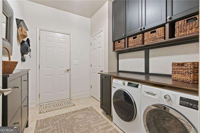 laundry room with cabinet space, washing machine and clothes dryer, light tile patterned flooring, and baseboards