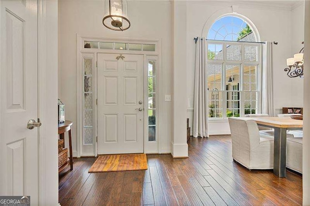 foyer with dark wood finished floors and baseboards