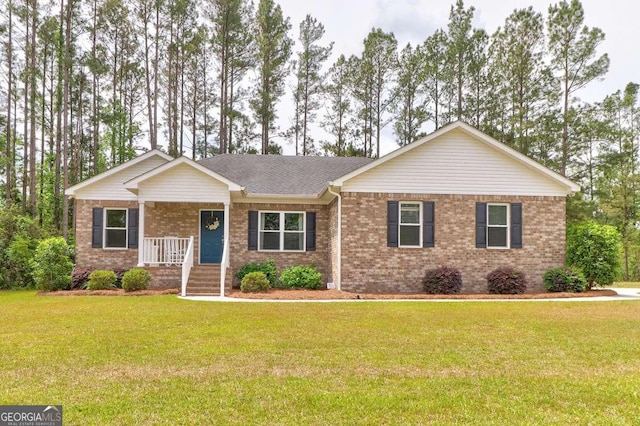 220 Candleberry Way, Guyton, GA 31312 - single story home with covered porch, a front lawn, brick siding, and a shingled roof