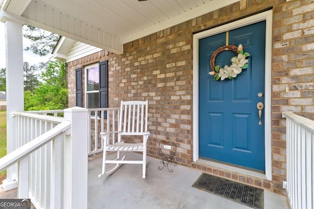 220 Candleberry Way, Guyton, GA 31312 - doorway to property featuring brick siding and covered porch