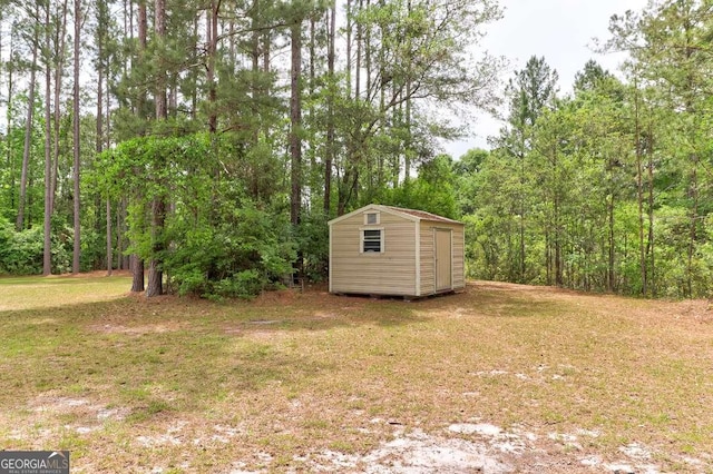 220 Candleberry Way, Guyton, GA 31312 - view of grassy yard with a storage shed, an outdoor structure, and a wooded view