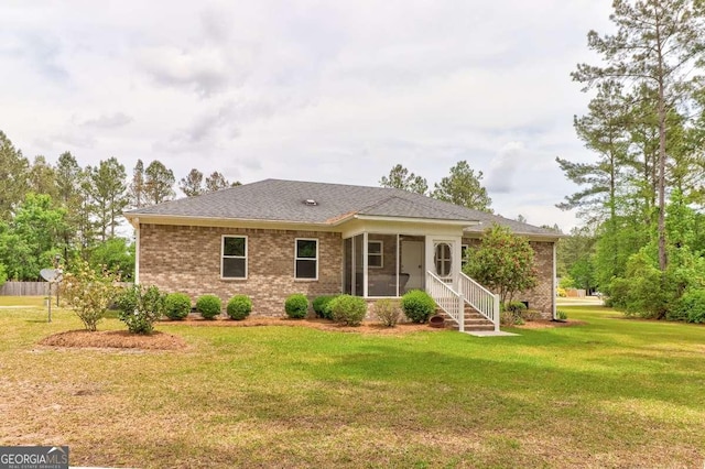 220 Candleberry Way, Guyton, GA 31312 - view of front of house featuring a sunroom, a front yard, brick siding, and a shingled roof