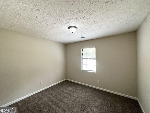 3879 Mcgill Ln, Decatur, GA 30034 - unfurnished room with baseboards, dark colored carpet, and a textured ceiling
