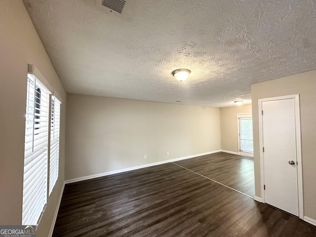 3879 Mcgill Ln, Decatur, GA 30034 - empty room featuring dark wood-style flooring, a textured ceiling, and baseboards
