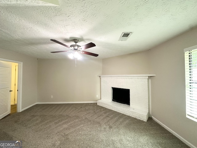 3879 Mcgill Ln, Decatur, GA 30034 - unfurnished living room featuring a ceiling fan, carpet, a brick fireplace, baseboards, and a textured ceiling