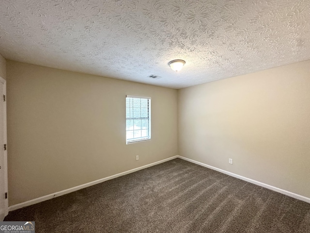 3879 Mcgill Ln, Decatur, GA 30034 - empty room featuring a textured ceiling, baseboards, and dark carpet