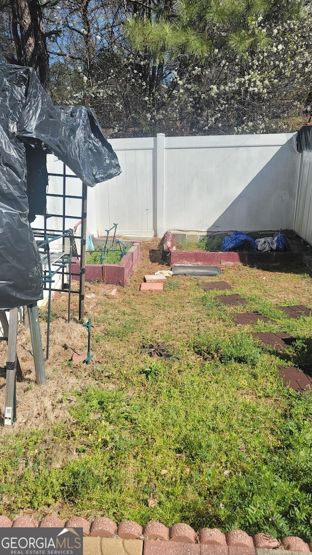 6880 Mountain Cir, Riverdale, GA 30274 - view of yard with a vegetable garden and fence