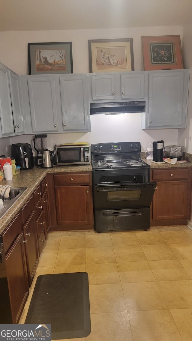6880 Mountain Cir, Riverdale, GA 30274 - kitchen featuring stainless steel microwave, black electric range oven, under cabinet range hood, light tile patterned floors, and a sink