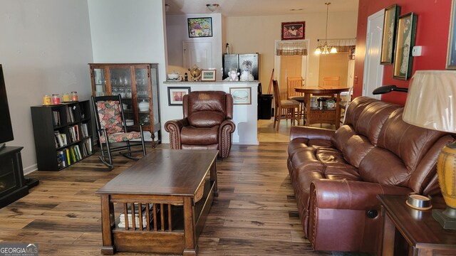 6880 Mountain Cir, Riverdale, GA 30274 - living room featuring wood finished floors and a chandelier