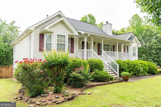 ranch-style home featuring covered porch, a chimney, stairs, and roof with shingles