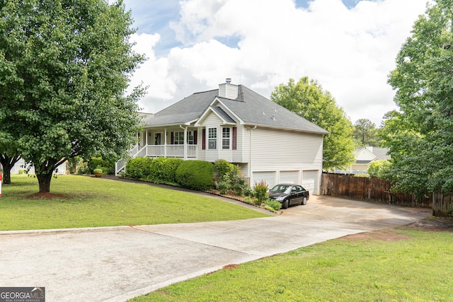 rear view of property featuring covered porch, a garage, a chimney, and concrete driveway