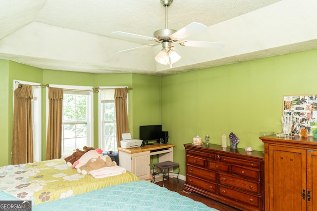 bedroom featuring a ceiling fan, baseboards, and wood finished floors