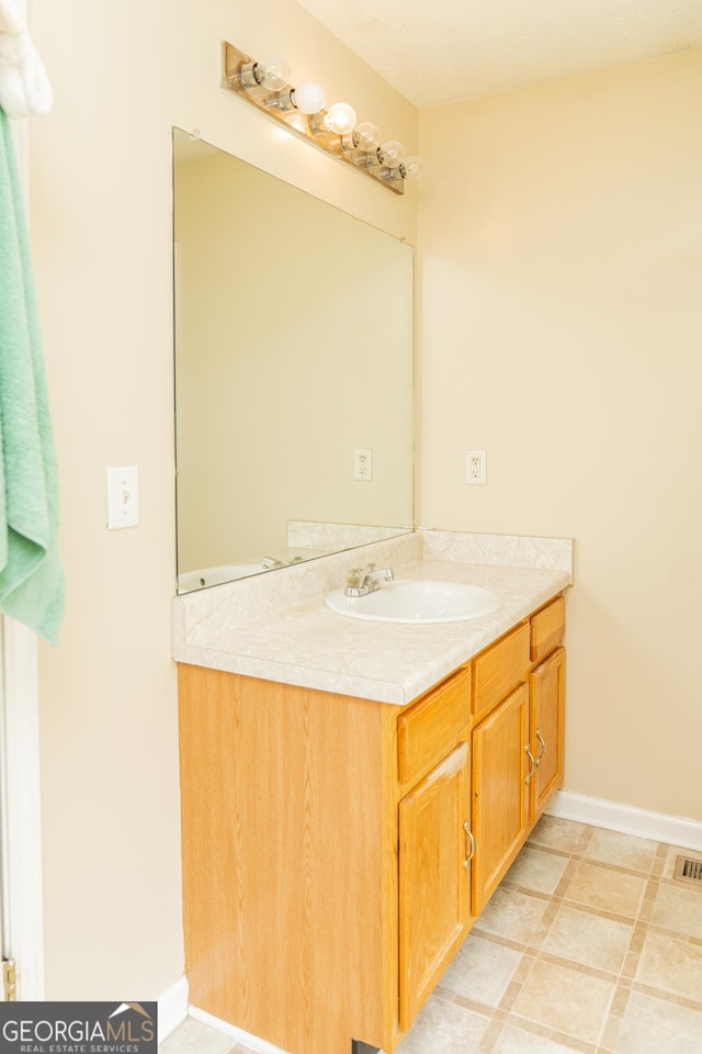 bathroom featuring vanity and baseboards