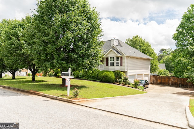 view of front of property featuring driveway, a garage, and a chimney