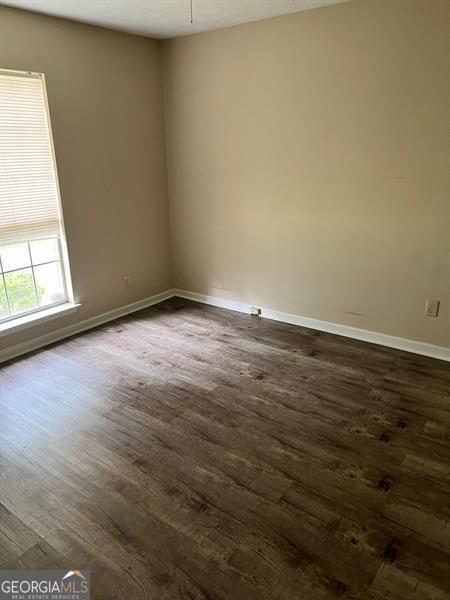 432 Manor Estates Dr, Stockbridge, GA 30281 - empty room with dark wood-type flooring and baseboards