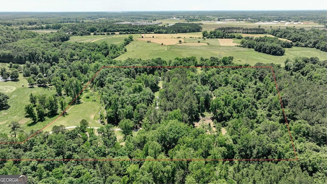 aerial overview of property's location featuring property parcel outlined and a forest