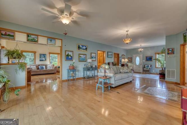 275 Everetts Vw, Blairsville, GA 30512 - living room featuring wood finished floors, a chandelier, a ceiling fan, and baseboards