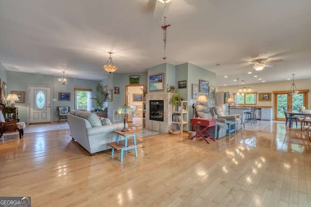 275 Everetts Vw, Blairsville, GA 30512 - living area featuring ceiling fan, a chandelier, wood finished floors, and a glass covered fireplace