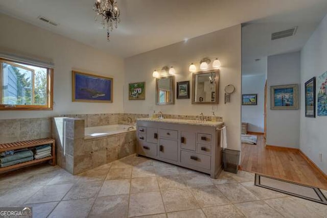275 Everetts Vw, Blairsville, GA 30512 - bathroom with a bath, double vanity, and a chandelier