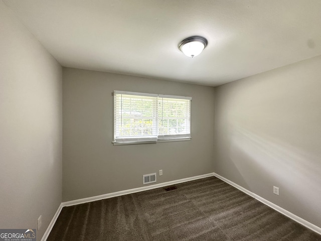 2651 Lois Ln SE, Atlanta, GA 30315 - empty room with baseboards and dark colored carpet