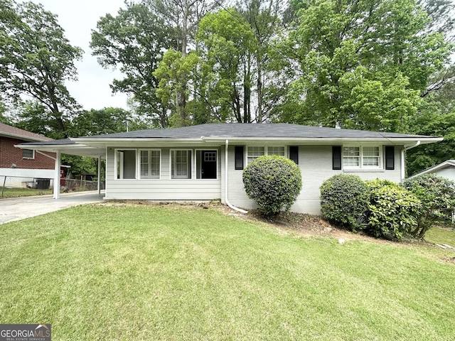 2651 Lois Ln SE, Atlanta, GA 30315 - single story home featuring concrete driveway, a front yard, an attached carport, and brick siding