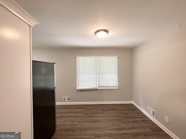 2651 Lois Ln SE, Atlanta, GA 30315 - unfurnished dining area with dark wood-style flooring and baseboards