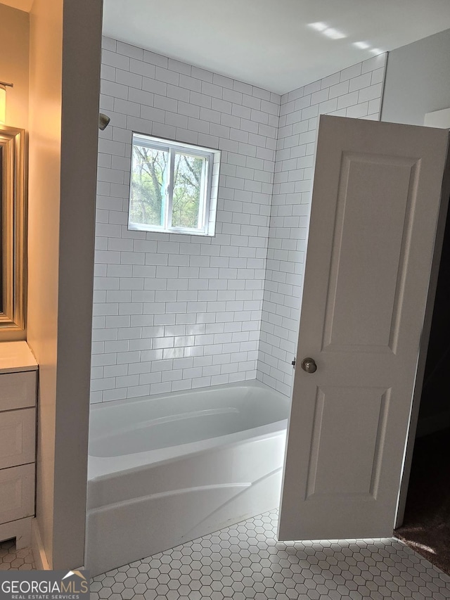 4075 SW Fairburn Ave SW, Atlanta, GA 30331 - bathroom with tub / shower combination, vanity, and tile patterned floors