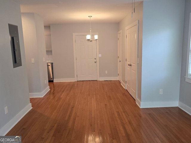 4075 SW Fairburn Ave SW, Atlanta, GA 30331 - hallway with wood finished floors, a chandelier, and electric panel