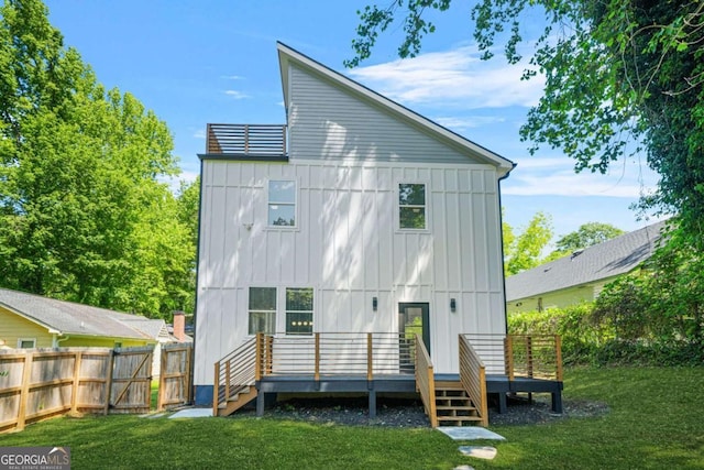 back of house with board and batten siding and a deck