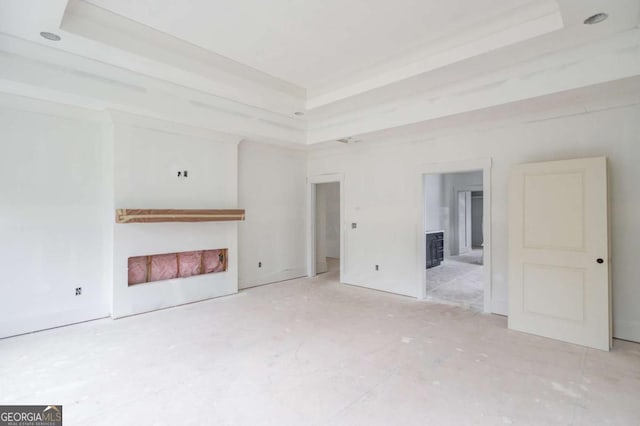unfurnished living room featuring a tray ceiling