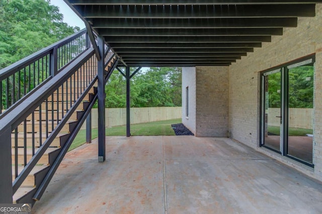 view of patio / terrace with stairs and fence