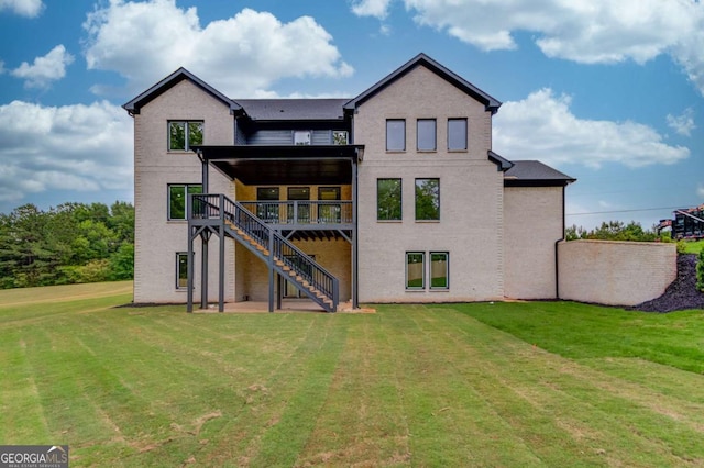 back of property with stairs, a yard, and a wooden deck