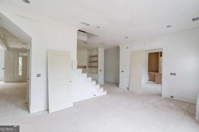 unfurnished living room with stairway