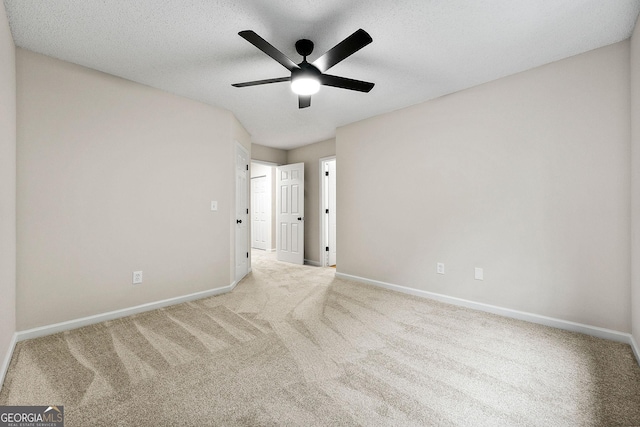 unfurnished bedroom with carpet flooring, baseboards, a textured ceiling, and ceiling fan