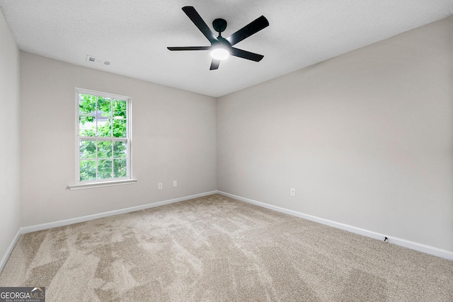 unfurnished room featuring carpet flooring, baseboards, and a ceiling fan