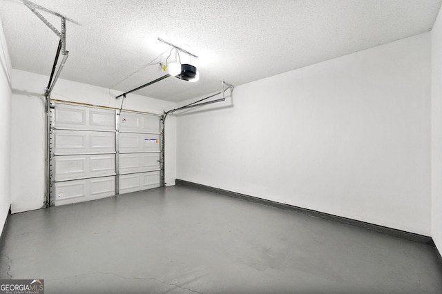 garage with a garage door opener and baseboards